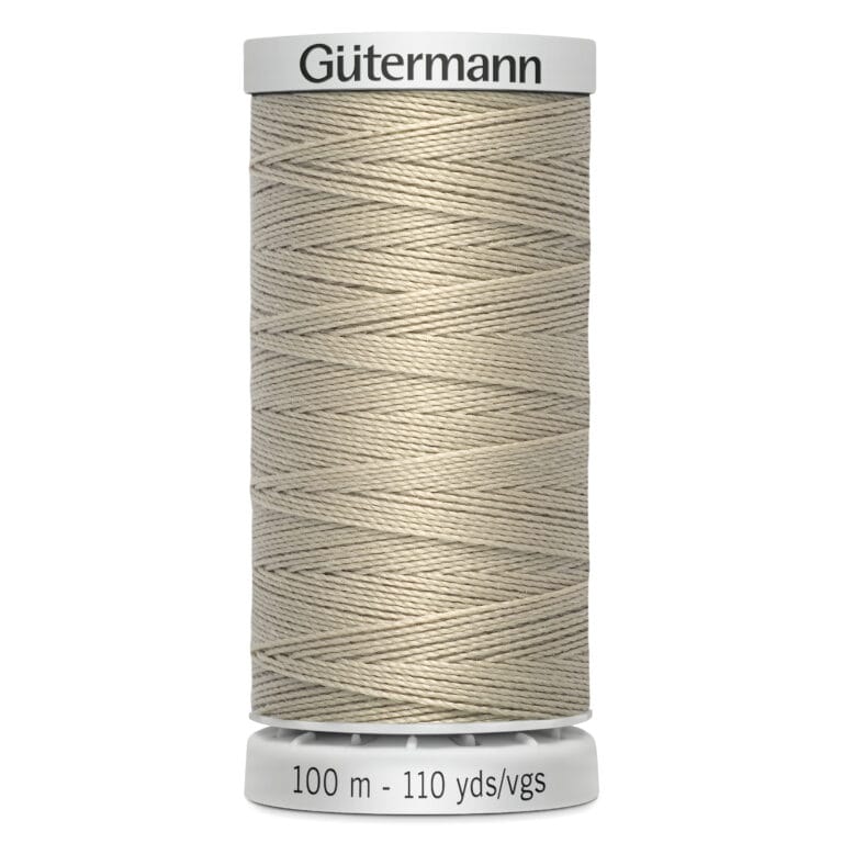 A spool of Gütermann polyester thread in a beige color. The spool label shows "100 m - 110 yds/vgs" indicating the length of the thread. The thread is neatly wound around the spool.