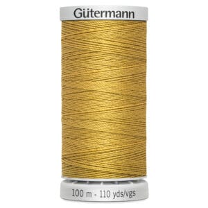 Spool of Gütermann gold sewing thread, 100 meters or 110 yards in length, with thread neatly wound in a crisscross pattern on a cylindrical holder.
