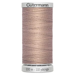 A spool of Gütermann thread in a light brown color, wrapped neatly around a white base. The label reads "Gütermann" on top and "100 m - 110 yds/vgs" on the bottom.