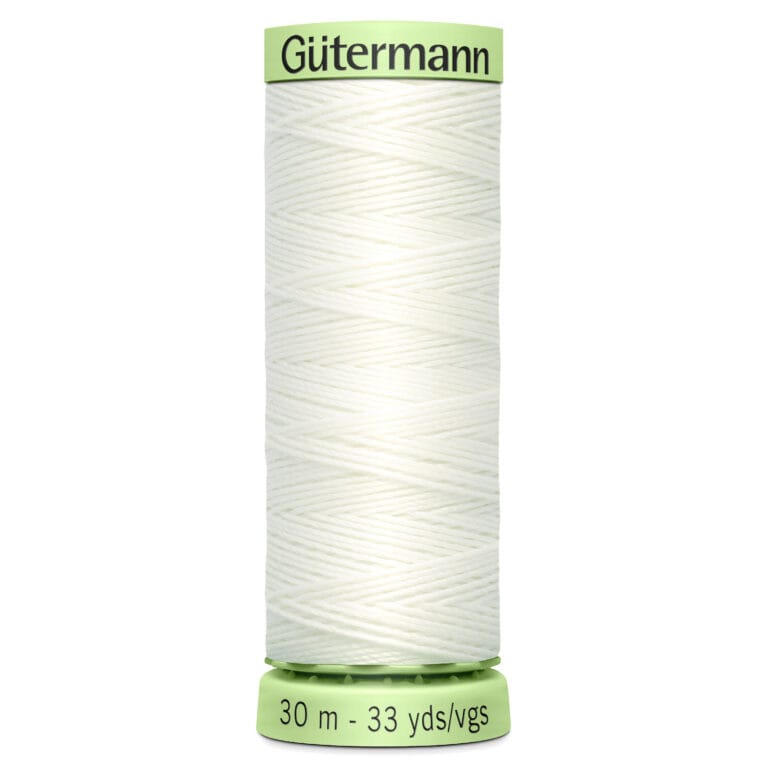 A spool of Gütermann white thread with zigzag windings. The label indicates 30 meters or 33 yards. The spool has light green ends with the brand name at the top.