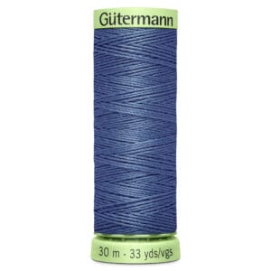 Spool of Gütermann blue sewing thread with a green label on top and bottom, indicating 30 meters or 33 yards.