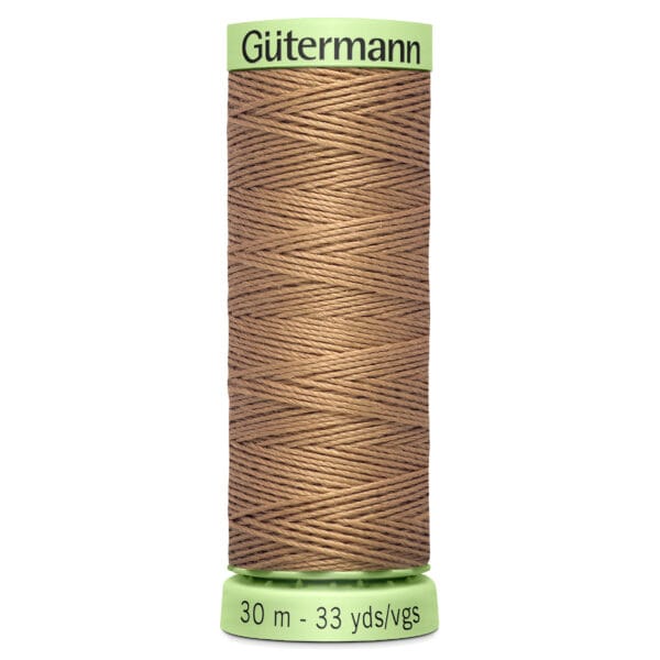 Spool of Gütermann brown sewing thread labeled with "30 m - 33 yds/vgs." The spool has a green top and bottom, with thread neatly wound in a crisscross pattern.