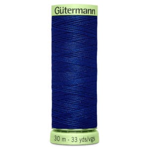 A spool of Gütermann blue thread, labeled with measurements of 30 meters and 33 yards. The spool has a light green top and bottom where the brand name and thread length are printed.