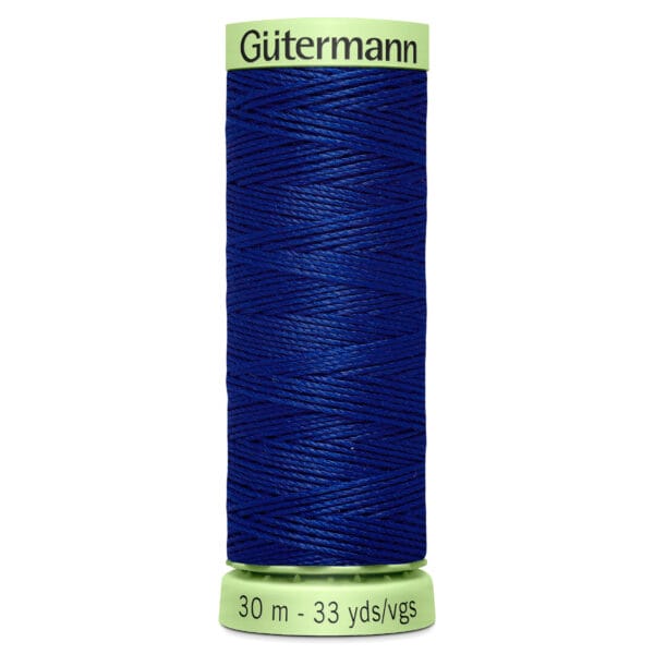 A spool of Gütermann blue thread, labeled with measurements of 30 meters and 33 yards. The spool has a light green top and bottom where the brand name and thread length are printed.