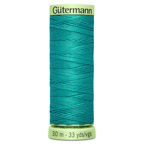 A spool of Gütermann sewing thread in a bright teal color, labeled with 30 meters (33 yards) on the bottom. The thread is neatly wound around the spool.