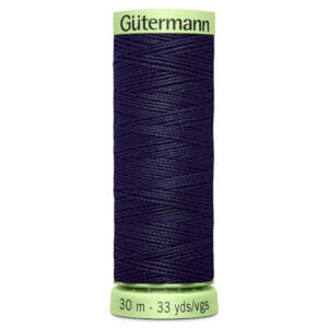 A spool of dark blue Gutermann thread, wrapped neatly, with a light green cap and base. The base is labeled "30 m - 33 yds/vgs.