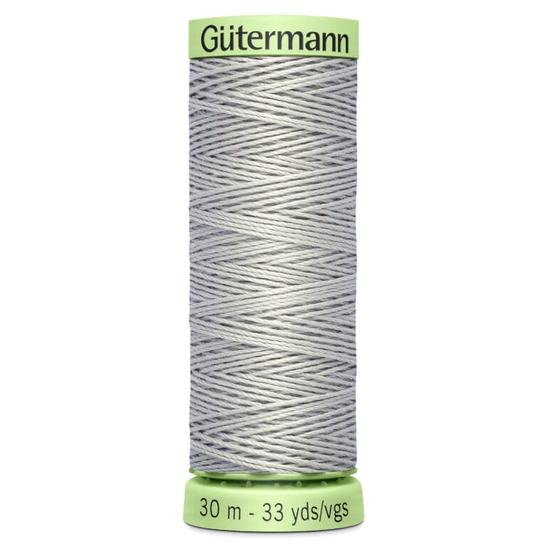 A spool of Gütermann thread in light gray, with a green top and bottom. The label shows "30 m - 33 yds/vgs" indicating the length of the thread.