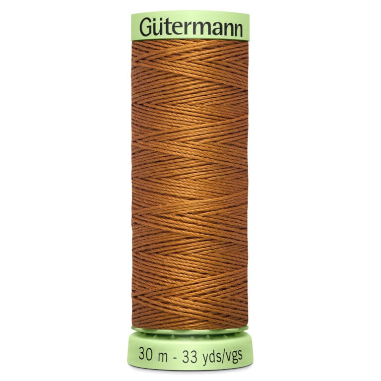 A spool of Gütermann brown thread on a light green base. The label indicates a length of 30 meters or 33 yards. The thread is neatly wound around the spool.