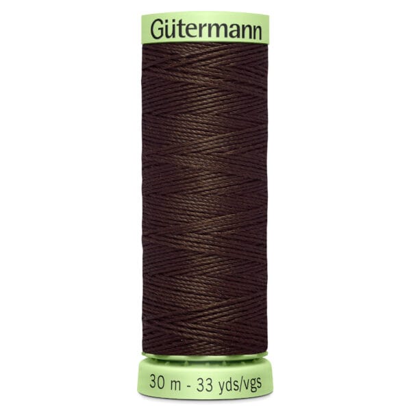 A spool of Gütermann dark brown thread, labeled with "30 m - 33 yds/vgs" on the bottom and a light green cap. The thread is neatly wound around the spool.