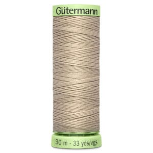 A spool of Gütermann beige thread, 30 meters or 33 yards long, with a green label at the top and bottom.