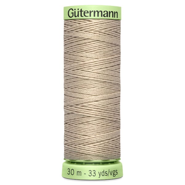 A spool of Gütermann beige thread, 30 meters or 33 yards long, with a green label at the top and bottom.