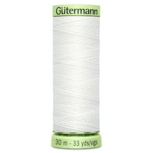 A green spool of Gütermann white sewing thread, labeled with "30 m - 33 yds/vgs" at the bottom. The thread is neatly wound around the spool.