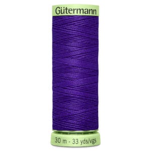 A spool of Gütermann thread, colored in deep purple, with green ends. The label displays "30 m - 33 yds/vgs.