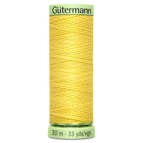 A spool of yellow Gütermann thread, with a pale green base and top. The text on the base reads "30 m - 33 yds.