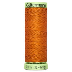 A spool of Gütermann thread in bright orange. The label displays "30 m - 33 yds/vgs" at the bottom, indicating the length of the thread.