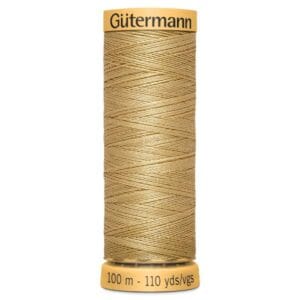 A spool of Gütermann sewing thread in a light golden color. The spool shows measurements of 100 meters or 110 yards.