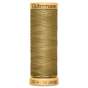 Spool of Gütermann gold metallic thread, 100 meters (110 yards), with detailed texture and sheen, wound neatly on a cylindrical spool with labels on top and bottom.
