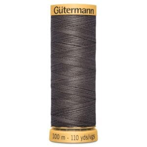 A spool of Gütermann sewing thread with a dark gray color. The spool is labeled with "Gütermann" on the top and "100 m - 110 yds" at the bottom. The thread is neatly wound around the spool.
