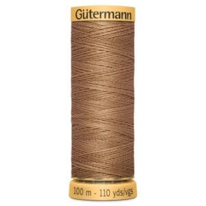 A spool of Gütermann sewing thread in a brown hue is displayed. The spool is labeled with "100 m - 110 yds" and has yellow caps on both ends. The thread is neatly wound around the spool.