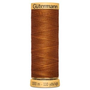 A spool of Gütermann polyester thread in a rich brown color. The label indicates it is 100 meters or 110 yards long. The thread is neatly wound, with a yellow top and base displaying the brand name and measurements.