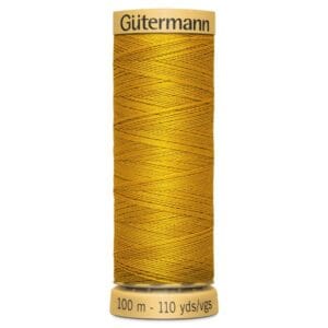 A spool of Gütermann yellow sewing thread, labeled with "100 m - 110 yds" on the bottom and "Gütermann" on top. The thread is tightly wound and displayed vertically against a plain background.