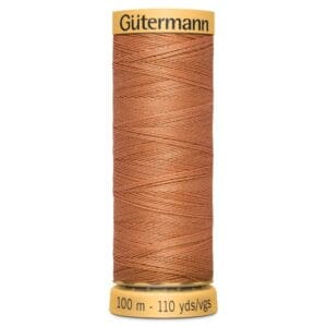 A spool of Gütermann thread in a copper color, with a label showing 100 meters and 110 yards. The spool has a yellow cap and base.