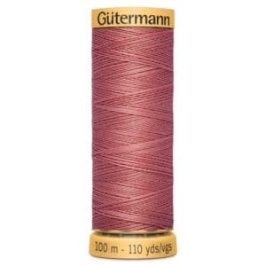 Spool of Gütermann thread in a muted pink color. The label at the top displays the brand name, and the bottom label indicates the length as 100 meters or 110 yards.