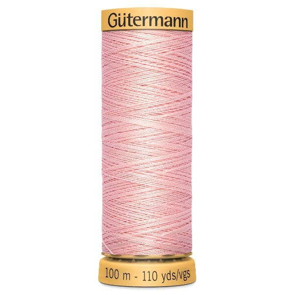 Spool of Gütermann thread in light pink, showing intricate crisscross windings. The spool indicates a length of 100 meters or 110 yards.