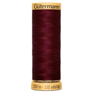 A spool of Gütermann thread in deep red. It is labeled 100 meters (110 yards) on the base.