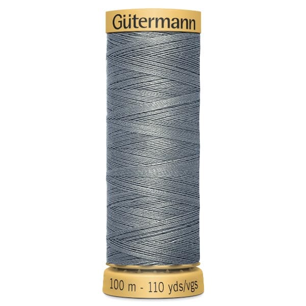 A spool of Gütermann thread, labeled "100 m - 110 yds," with gray thread. The top and bottom edges of the spool are yellow.