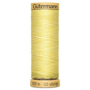 A spool of Gütermann thread in a light yellow color. The spool holds 100 meters or 110 yards of thread.