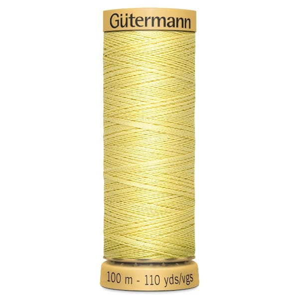 A spool of Gütermann thread in a light yellow color. The spool holds 100 meters or 110 yards of thread.