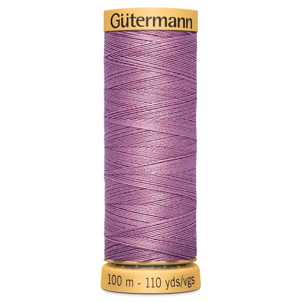 A spool of Gütermann sewing thread in a light purple color, wrapped neatly around the spool. The label indicates a length of 100 meters or 110 yards.