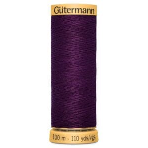 A spool of Gütermann thread in dark purple, labeled with 100 meters and 110 yards on the bottom. The top also displays the brand name.