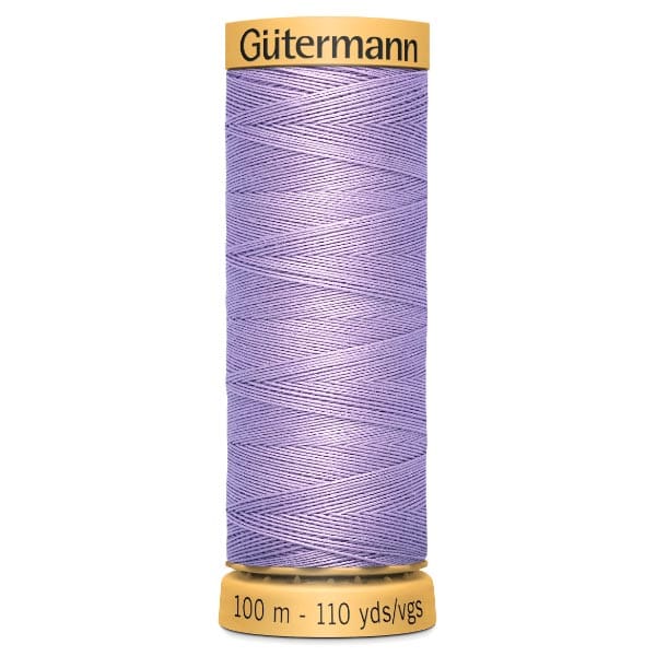 A spool of Gütermann thread in a light purple color, labeled with "100 m - 110 yds" on the bottom and "Gütermann" on the top.