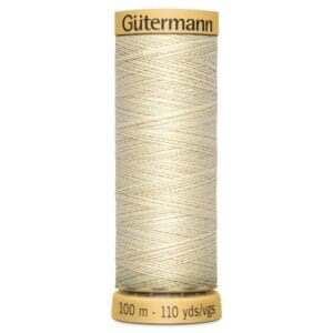 A spool of Gütermann sewing thread, labeled as 100 meters or 110 yards. The thread is light beige, neatly wound, with a yellow cap and base displaying the brand and length information.