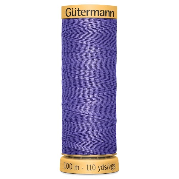 A spool of Gütermann thread with purple yarn. The spool displays "100 m - 110 yds/vgs" at the bottom, indicating the length of the thread.