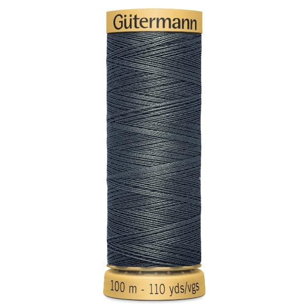 A spool of Gütermann thread, navy blue in color, labeled as 100 meters or 110 yards. The spool has a yellow top and bottom.