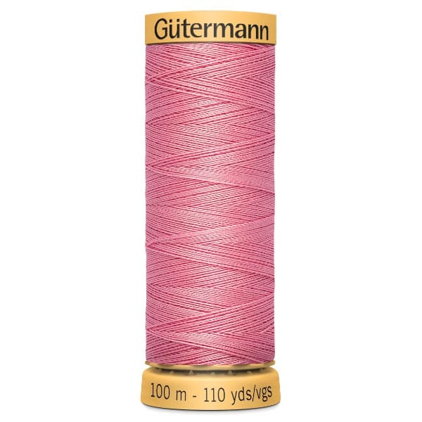 Spool of Güttermann pink sewing thread, labeled with a length of 100 meters (110 yards).