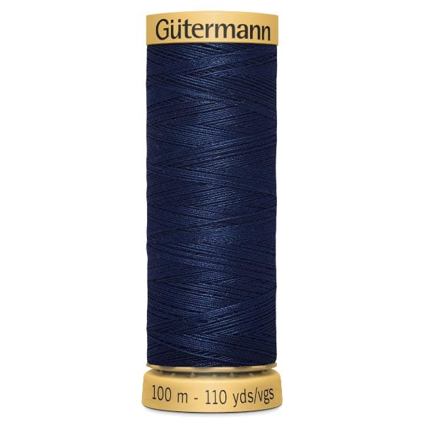 A spool of dark blue Gütermann sewing thread, labeled with measurements of 100 meters and 110 yards.