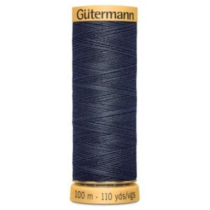 A spool of Gütermann thread in dark blue, labeled with "100 m - 110 yds/vgs." The spool has a yellow top and bottom, with the brand name "Gütermann" on the top.