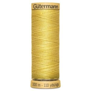 A spool of Gütermann yellow sewing thread, labeled with "100 m - 110 yds" at the base. The thread is neatly wound and has a warm golden hue.