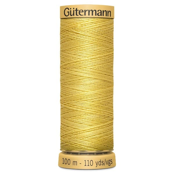 A spool of Gütermann yellow sewing thread, labeled with "100 m - 110 yds" at the base. The thread is neatly wound and has a warm golden hue.