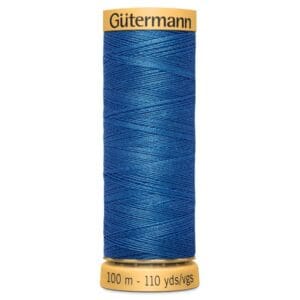 A spool of Gütermann blue sewing thread, labeled with "100 m - 110 yds/vgs" at the bottom and "Gütermann" at the top. The thread is tightly wound around the spool.