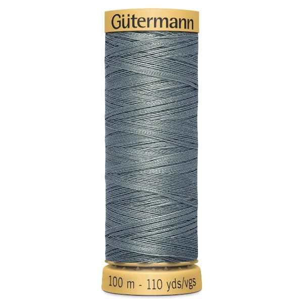 A spool of Gütermann thread with light blue polyester thread, labeled "100 m - 110 yds/vgs" on the base. The top of the spool is yellow, featuring the brand name "Gütermann.