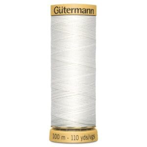 A spool of Gütermann white sewing thread, holding 100 meters (110 yards) of thread. The spool has a beige top and base with black text displaying the brand name and length in meters and yards.