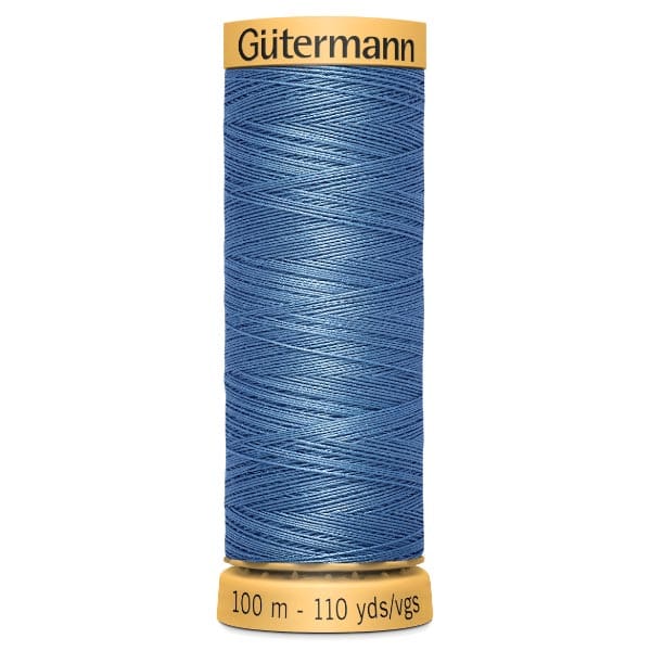 A spool of Gütermann sewing thread in blue, wrapped tightly around the spool. The spool has yellow ends, with "Gütermann" written on the top, and "100 m - 110 yds" on the bottom.