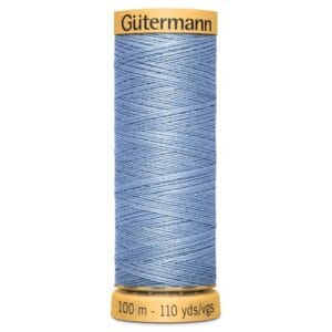 A spool of Gütermann thread in light blue, with 100 meters (110 yards) indicated on the bottom label. The spool features a textured pattern of neatly wound thread.
