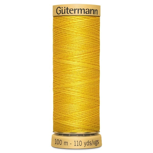 Spool of Gütermann sewing thread in bright yellow. The label reads "100 m - 110 yds/vgs." The thread is wound neatly around the spool.