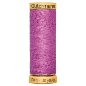 A spool of Gütermann thread in vibrant pink, wrapped neatly around the spool. The label reads "Gütermann" on top with "100 m - 110 yds" on the bottom.